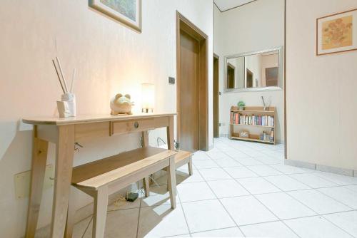 a room with a table and a bench on a tiled floor at QUEEN HOME Bianca in Bologna