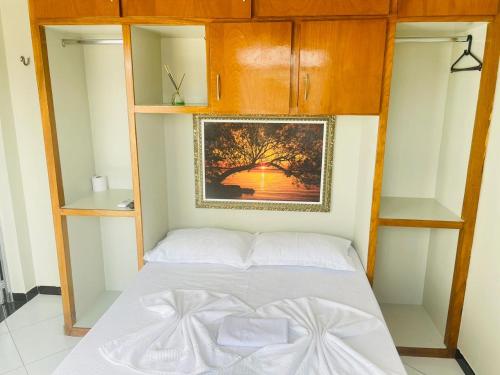 a bedroom with a bed in a room with shelves at Hotel Shalom in Juazeiro do Norte