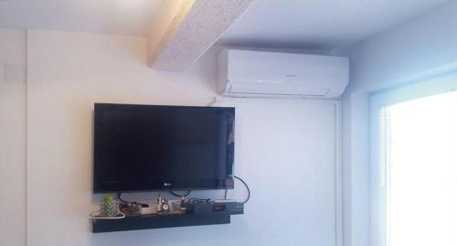 a flat screen tv on a wall in a room at Apartman Pazova in Soko Banja