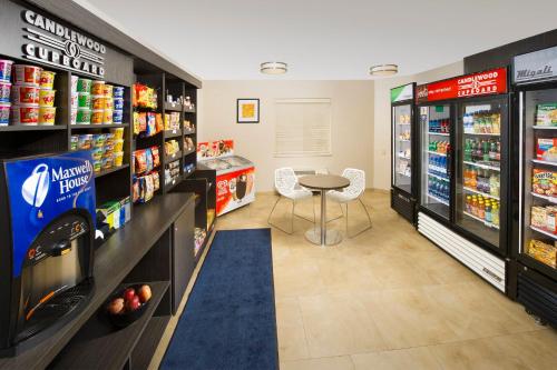 a grocery store aisle with a small table in the middle at Candlewood Suites Richmond - South by IHG in Richmond