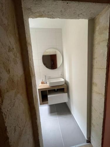 a bathroom with a sink and a mirror at Une petite escale in Lectoure