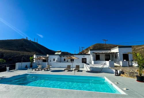 a swimming pool in front of a house at O Mylos in Ermoupoli