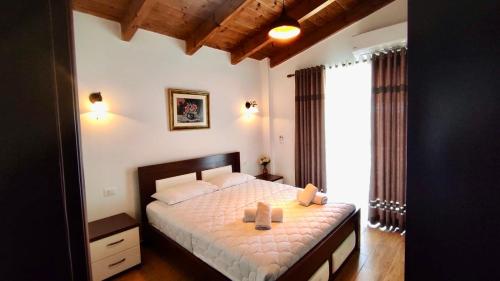 a bedroom with a bed with two boxes on it at Summer Dreams in Ksamil