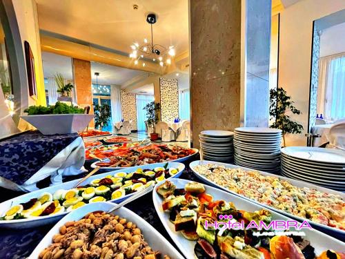 a buffet line with many different types of food at HOTEL AMBRA - Fronte Mare - Vicinissimi al Centro in Milano Marittima