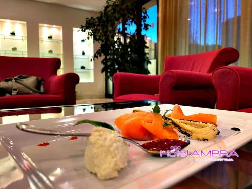 a plate of food on a table in a room at HOTEL AMBRA - Fronte Mare - Vicinissimi al Centro in Milano Marittima
