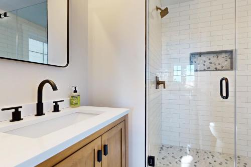 a bathroom with a sink and a shower at Mountain Sunset Villa in Waterville Valley