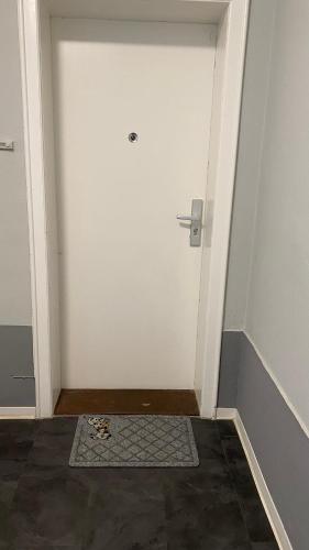 an empty room with a white door with a mat at ZE City Apartments in Hannover