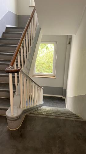 a staircase with a window in a house at ZE City Apartments in Hannover