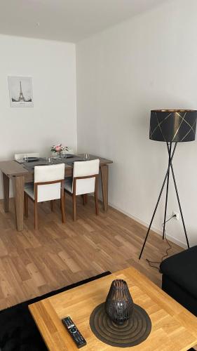 a living room with a table and chairs and a table at ZE City Apartments in Hannover