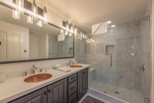 a bathroom with two sinks and a shower at Enjoy High End Appliances, Private Hot Tub & Amazing Views at Deer Valley Black Bear Penthouse B! in Park City