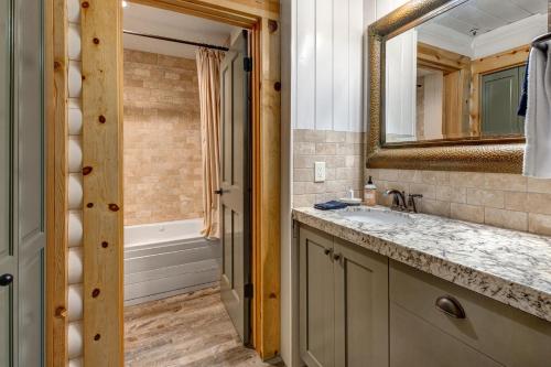 a bathroom with a sink and a mirror and a tub at Luxury Condo Near Year-Round Recreation, Free Shuttle & Hot Tub! Deer Valley Comstock Lodge 302 in Park City