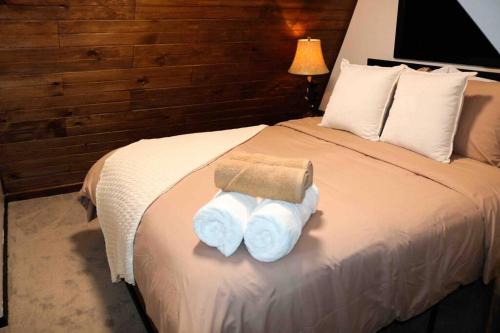 a hotel room with a bed with towels on it at The New Luxury Cabin PetFriendly Pocono Summit in Pocono Summit