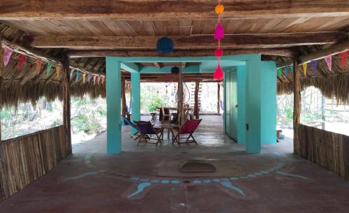 a room with chairs and a table in a house at Rancho Aak in Yaxché