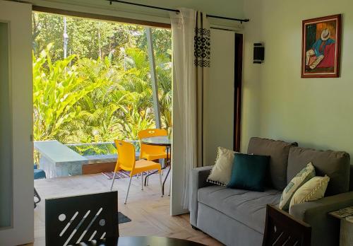 a living room with a couch and a table at Villa Akala in Cocles
