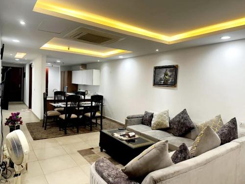 een woonkamer met een bank en een tafel bij 2 bed Apartment in Gold crest apartment in Lahore