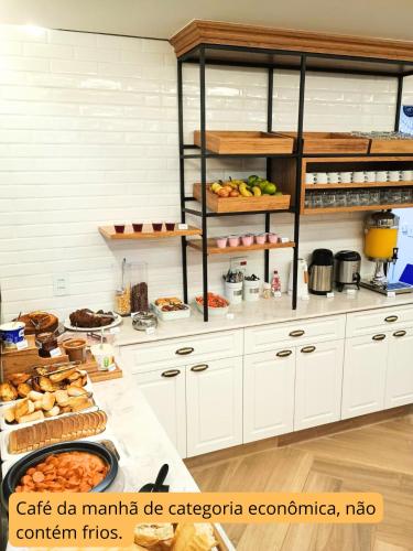 a kitchen filled with lots of food on a counter at RP HOTEL in Ribeirão Preto