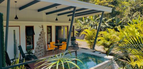 a house with a swimming pool and a patio at Villa Akala in Cocles