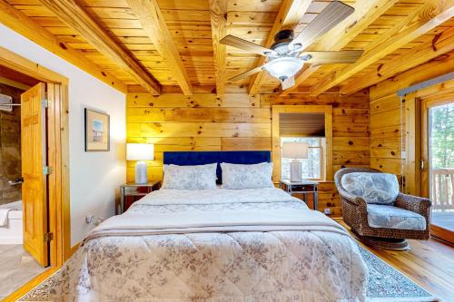 a bedroom with a bed and a ceiling fan at Bird's Nest in Saluda