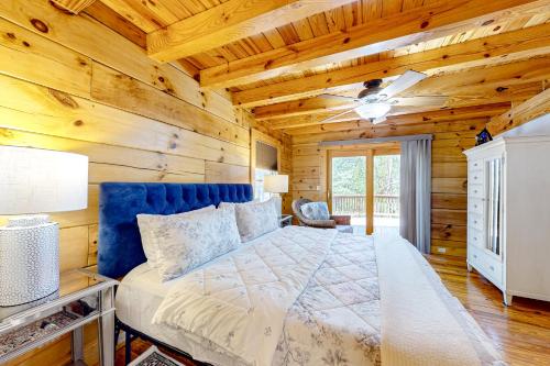 a bedroom with a bed and a wooden wall at Bird's Nest in Saluda