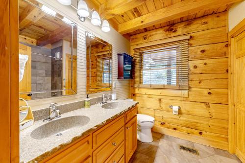 a bathroom with two sinks and a toilet at Bird's Nest in Saluda