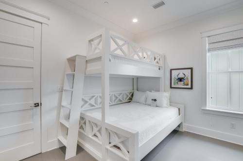 a white bedroom with a bunk bed and a window at Beach Village Resort By Liquid Life in Gulf Shores