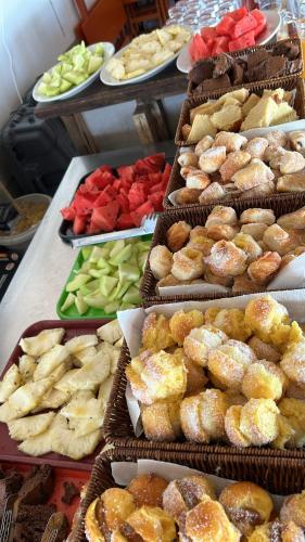 a display of different types of donuts and other foods at Oikos in Punta Del Diablo