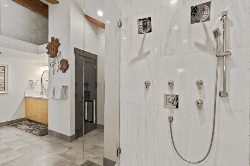 a bathroom with a shower with a glass door at Enjoy a Modern Luxury Design, Central Location, Hot Tub & Recreation! Deer Valley Fawngrove 1674 in Park City