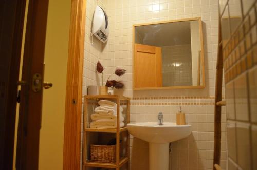 a bathroom with a sink and a mirror at Ojaranzo in Candeleda