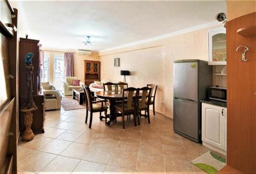 a kitchen and dining room with a table and a refrigerator at Apartments Marina in Rafailovici