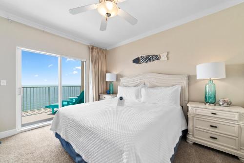 a bedroom with a bed and a large window at Crystal Shores West 1204 in Gulf Shores
