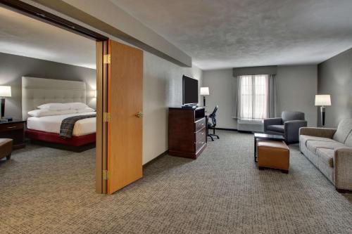 a hotel room with a bed and a couch at Drury Inn & Suites San Antonio Northwest Medical Center in San Antonio