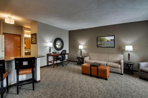a living room with a couch and a table at Drury Inn & Suites San Antonio Northwest Medical Center in San Antonio