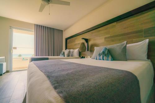 a hotel room with two beds and a window at Oceana Resort & Conventions in Monterrico