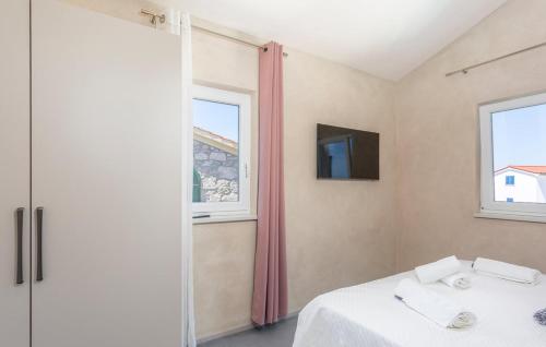 a bedroom with a bed and a tv and windows at Villa Jazz - Island Krk SPA Oasis in Krk