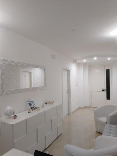 a living room with white walls and white furniture at B&B I like salento in Uggiano la Chiesa