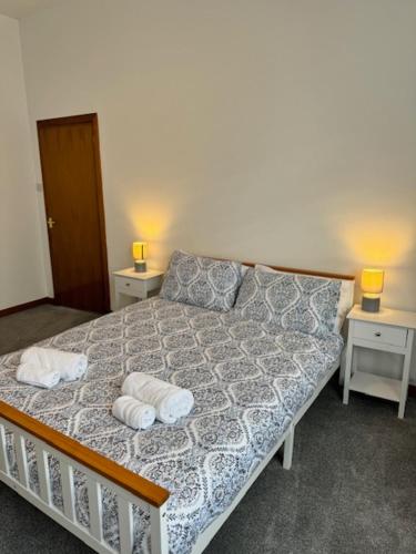 a bedroom with a bed with two towels on it at Ben Lomond Apartment in Alexandria
