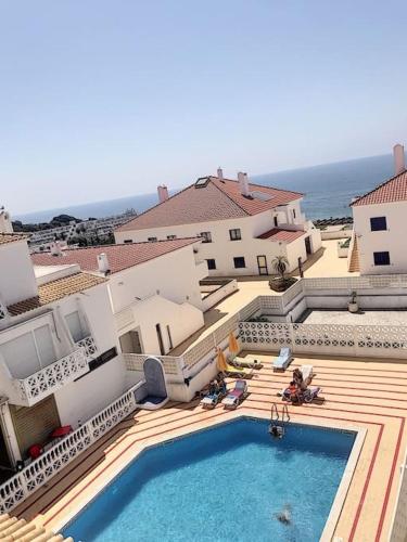 a swimming pool in front of a building at OURA WHITE VIEW Beach 2 min walk sea in Albufeira