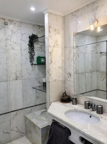 a white bathroom with a sink and a mirror at OURA WHITE VIEW Beach 2 min walk sea in Albufeira