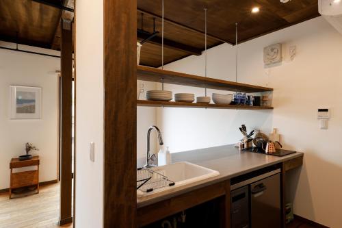 a kitchen with a sink and a counter at 貸別荘 楓-Fū- 有馬 in Arima