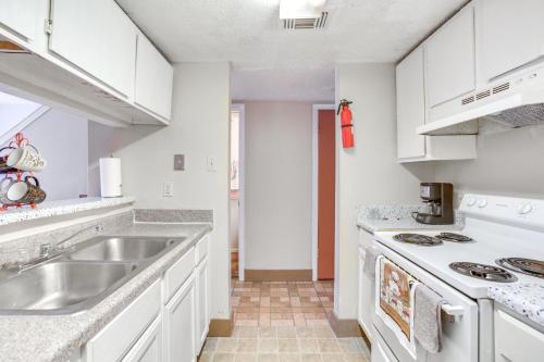 a kitchen with white cabinets and a sink at Convenient Harvey Apt - 12 Mi to French Quarter! in Harvey