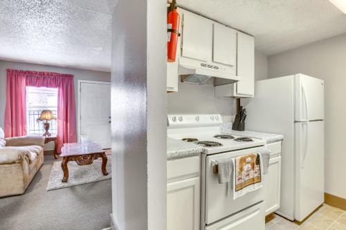 a kitchen with a stove and a white refrigerator at Convenient Harvey Apt - 12 Mi to French Quarter! in Harvey