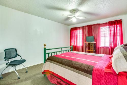 a bedroom with a bed and a chair and a tv at Convenient Harvey Apt - 12 Mi to French Quarter! in Harvey