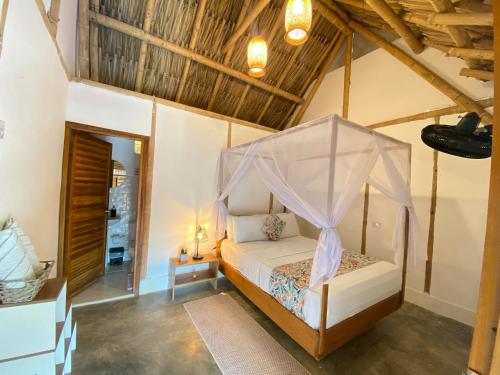 a bedroom with a bed with a canopy at Rincon del Mar Palomino in Palomino