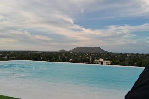 a swimming pool with a view of a mountain at Appartamento Sidney in San Fernando de Monte Cristi