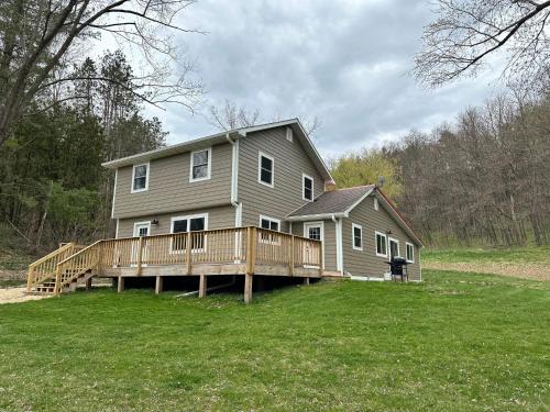 a large house with a large deck on a yard at Huge Secluded 5 Bedroom 2 12 Bathroom Home! in Ontario