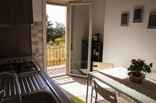 a kitchen with a door leading to a patio at Romagraziosa Rent in Rome