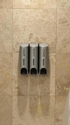 three silver batteries are on a tile wall at DOWNTOWN, LUXURY CONDO, CN TOWER, ROGERS CENTER, SCOCIA ARENA, UNOBSTRUCTED VIEW in Toronto