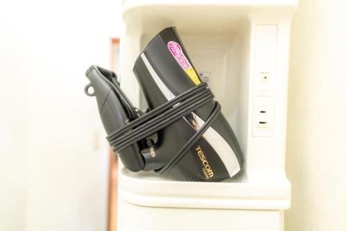 a black bag is inside of a white locker at 3BR Entire House for7 #91Rated TraditionCozy Japanese Villa in Ikebukuro 6mins St in Tokyo