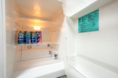 a refrigerator with cans of soda in it at 3BR Entire House for7 #91Rated TraditionCozy Japanese Villa in Ikebukuro 6mins St in Tokyo