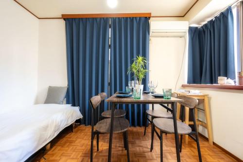 a room with a table and chairs and a bed at 3BR Entire House for7 #91Rated TraditionCozy Japanese Villa in Ikebukuro 6mins St in Tokyo